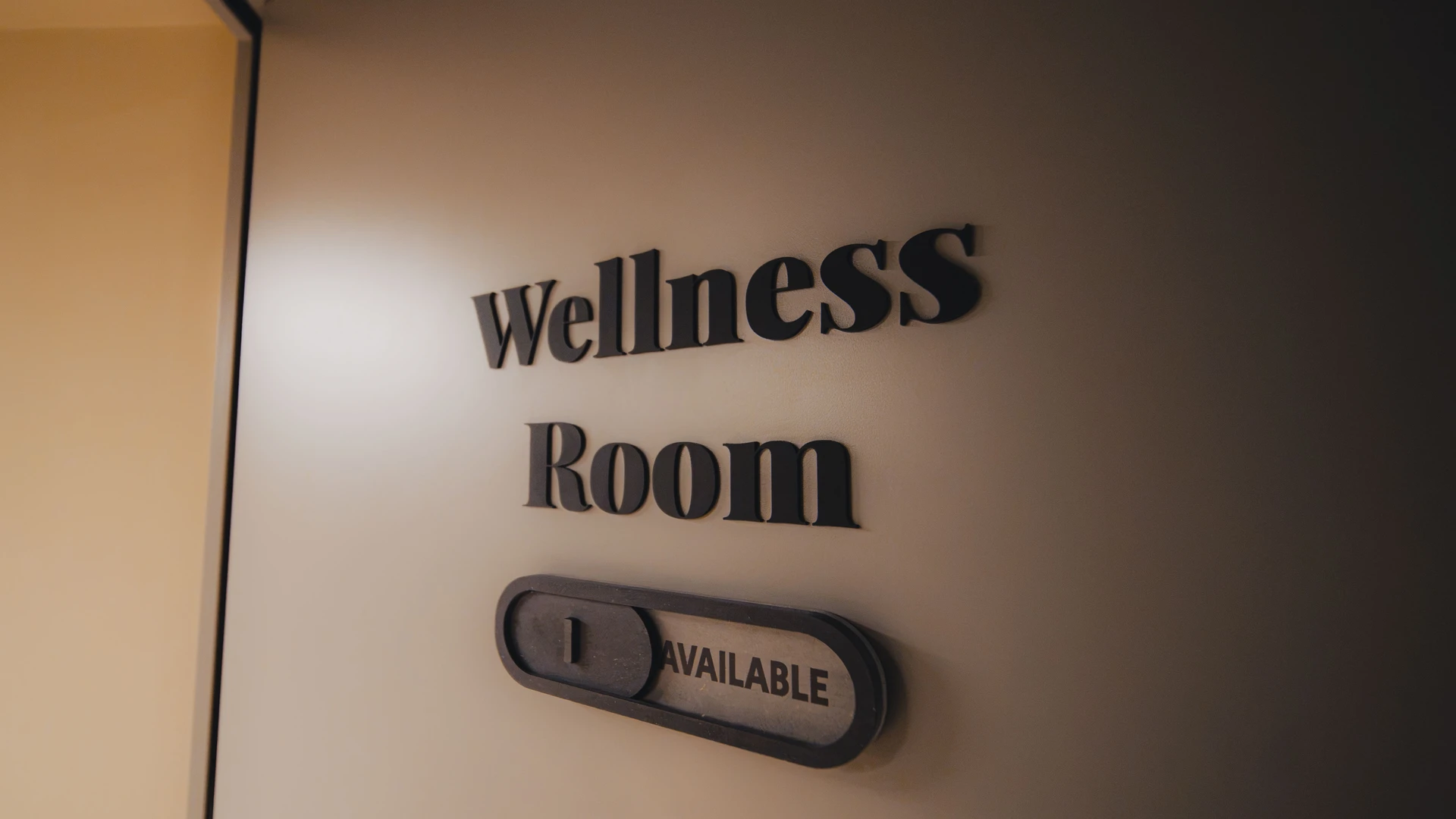 A Wellness Room sign at Elementa Workspace showing the room is available, a dedicated space tracked and accounted for